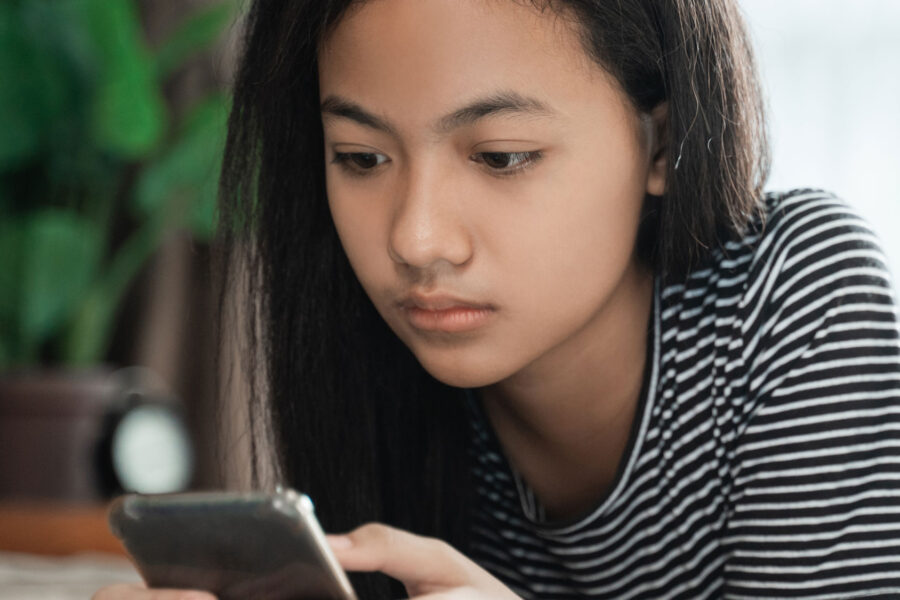 Teen checking phone