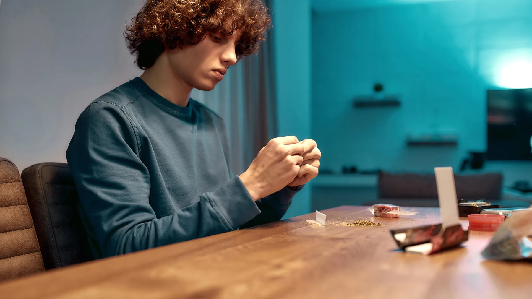 teenager rolling marijuana